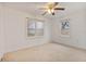 Bright bedroom with ceiling fan, and natural light from two windows at 119 E Central Ave, Bushnell, FL 33513