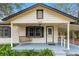 Close-up of the front porch, showing a porch swing, well-kept landscaping, and the front door at 119 E Central Ave, Bushnell, FL 33513