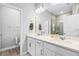 Bathroom with double vanity, framed mirror, and tiled shower at 1194 Spotted Sandpiper Loop, Winter Springs, FL 32708