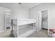 Bright bedroom featuring a white bunk bed and an adjacent bathroom and closet for ample storage at 1194 Spotted Sandpiper Loop, Winter Springs, FL 32708