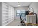 Bright bedroom with large windows, desk, and modern shelving at 1194 Spotted Sandpiper Loop, Winter Springs, FL 32708