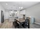 Bright kitchen features stainless steel appliances, white cabinets, and an eat-in island with modern pendant lighting at 1194 Spotted Sandpiper Loop, Winter Springs, FL 32708
