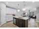 Open-concept kitchen with stainless steel appliances that flows into the living room, great for entertaining at 1194 Spotted Sandpiper Loop, Winter Springs, FL 32708