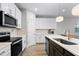 Stylish kitchen with stainless steel appliances, sleek white cabinets, and a center island at 1194 Spotted Sandpiper Loop, Winter Springs, FL 32708