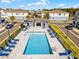 Inviting community pool area with comfortable lounge chairs and umbrellas for relaxing summer days at 1194 Spotted Sandpiper Loop, Winter Springs, FL 32708