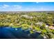 Wide angle view of an attractive lakeside community with docks and homes nestled in a green forest at 12002 Mckinnon Rd, Windermere, FL 34786