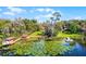 Stunning aerial view of homes along a lake, complete with private docks surrounded by verdant trees at 12002 Mckinnon Rd, Windermere, FL 34786