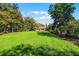 Expansive backyard with lush lawn and mature trees surrounding the property at 12002 Mckinnon Rd, Windermere, FL 34786