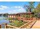 Beautiful covered dock on the water with a wooden walkway and ample space for relaxation and enjoying the waterfront views at 12002 Mckinnon Rd, Windermere, FL 34786