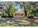 Inviting single-story home framed by mature trees and landscaping, offering a serene setting at 12002 Mckinnon Rd, Windermere, FL 34786
