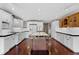 Spacious kitchen with white cabinets, black countertops, and a wooden island at 12002 Mckinnon Rd, Windermere, FL 34786