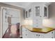 Elegant kitchen cabinets with glass doors and a light countertop at 12002 Mckinnon Rd, Windermere, FL 34786