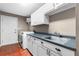 Well-equipped laundry room with modern washer, dryer, sink, and plenty of cabinet storage at 12002 Mckinnon Rd, Windermere, FL 34786