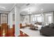 Spacious living room with hardwood floors and an open floor plan to a sunroom at 12002 Mckinnon Rd, Windermere, FL 34786