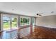 Bright living space features Saltillo tile flooring, and large windows offering backyard views at 12002 Mckinnon Rd, Windermere, FL 34786