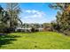 Picturesque water view from the lush green lawn, showcasing serene waterfront living at 12002 Mckinnon Rd, Windermere, FL 34786