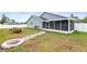 Spacious backyard features a screened-in porch and a rock fire pit at 12853 Maryland Woods Ct, Orlando, FL 32824