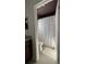 Cozy bathroom featuring a tile floor, shower curtain, and a plush bath mat, viewed from doorway at 12853 Maryland Woods Ct, Orlando, FL 32824