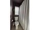 Charming bathroom with a hanging plant, a window with tie-up curtains, and a linen-textured shower curtain at 12853 Maryland Woods Ct, Orlando, FL 32824