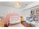 Charming Bedroom features a white crib, bright decor and closet storage at 12853 Maryland Woods Ct, Orlando, FL 32824