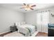 Neutral bedroom with ceiling fan, plush rug, and bright, natural light at 12853 Maryland Woods Ct, Orlando, FL 32824