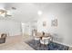 Bright dining area features a round wood table, pendant lighting, and neutral decor in an open-concept space at 12853 Maryland Woods Ct, Orlando, FL 32824