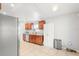 Well-lit kitchen with stainless steel appliances, wooden cabinets, and tile flooring provides ample space at 12853 Maryland Woods Ct, Orlando, FL 32824