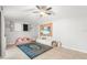 Bright living room features a ceiling fan, tiled floors and entertainment area at 12853 Maryland Woods Ct, Orlando, FL 32824