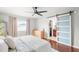 Spacious main bedroom with a ceiling fan, hardwood floors, a sliding door closet, and plenty of natural light at 12853 Maryland Woods Ct, Orlando, FL 32824