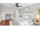 Spacious main bedroom with a ceiling fan, modern decor, and hardwood floors offers a relaxing retreat at 12853 Maryland Woods Ct, Orlando, FL 32824