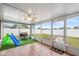 Enclosed patio with tiled floors, ceiling fan, slide and grill at 12853 Maryland Woods Ct, Orlando, FL 32824