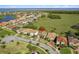 Aerial view of neighborhood, with a pin highlighting a home near a lake and expansive green space at 1330 Bucktail Ct, Kissimmee, FL 34746