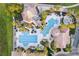 Aerial view of the luxurious community pools, lounging areas, and tropical landscaping at 1330 Bucktail Ct, Kissimmee, FL 34746