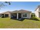 Home's backyard with a screened-in lanai featuring outdoor furniture, perfect for relaxing or entertaining guests outdoors at 1330 Bucktail Ct, Kissimmee, FL 34746