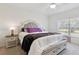 Stylishly decorated bedroom features a cozy bed, plush blanket and views to the outdoors at 1330 Bucktail Ct, Kissimmee, FL 34746