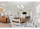 Open-concept dining area with stylish lighting, comfortable seating, and seamless flow to living spaces at 1330 Bucktail Ct, Kissimmee, FL 34746