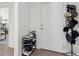 Interior view of an entryway with a shoe rack, adjacent to a doorway and white door at 1330 Bucktail Ct, Kissimmee, FL 34746