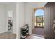 Welcoming entryway with neutral tones, a shoe rack, and a view through the screen door at 1330 Bucktail Ct, Kissimmee, FL 34746