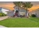 Charming single-story home with well-manicured lawn and mature palm trees in a warm, inviting setting at 1330 Bucktail Ct, Kissimmee, FL 34746