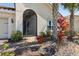 Inviting front porch area with brick pavers, vibrant foliage, and a secured screen door at 1330 Bucktail Ct, Kissimmee, FL 34746
