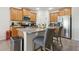 Bright kitchen with stainless steel appliances, granite countertops, a central island, and seating at 1330 Bucktail Ct, Kissimmee, FL 34746