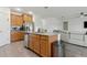 Open-concept kitchen with stainless steel appliances and an island, next to the main living space at 1330 Bucktail Ct, Kissimmee, FL 34746