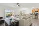 Bright living room featuring a large sectional sofa, seamless access to the outdoor patio and nearby kitchen at 1330 Bucktail Ct, Kissimmee, FL 34746