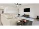 Inviting living room showcasing neutral tones, ample seating, and a large wall-mounted television at 1330 Bucktail Ct, Kissimmee, FL 34746