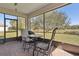 Enclosed patio with outdoor furniture set, offering a tranquil space with views of the lush, green landscape beyond at 1330 Bucktail Ct, Kissimmee, FL 34746