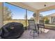 Screened-in lanai with patio furniture overlooks a large grassy field, perfect for outdoor relaxation and entertaining at 1330 Bucktail Ct, Kissimmee, FL 34746