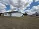Exterior view of the home with lush green grass and bright white facade at 13566 Sw 43Rd Cir, Ocala, FL 34473