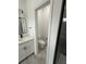Modern bathroom featuring a toilet room, a gray tile floor, and a white vanity with black hardware at 13566 Sw 43Rd Cir, Ocala, FL 34473