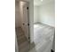 Open bedroom with sleek gray flooring next to a door to a walk-in closet and an entrance at 13566 Sw 43Rd Cir, Ocala, FL 34473