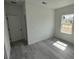 Bright bedroom featuring gray flooring, base molding, and a window at 13566 Sw 43Rd Cir, Ocala, FL 34473